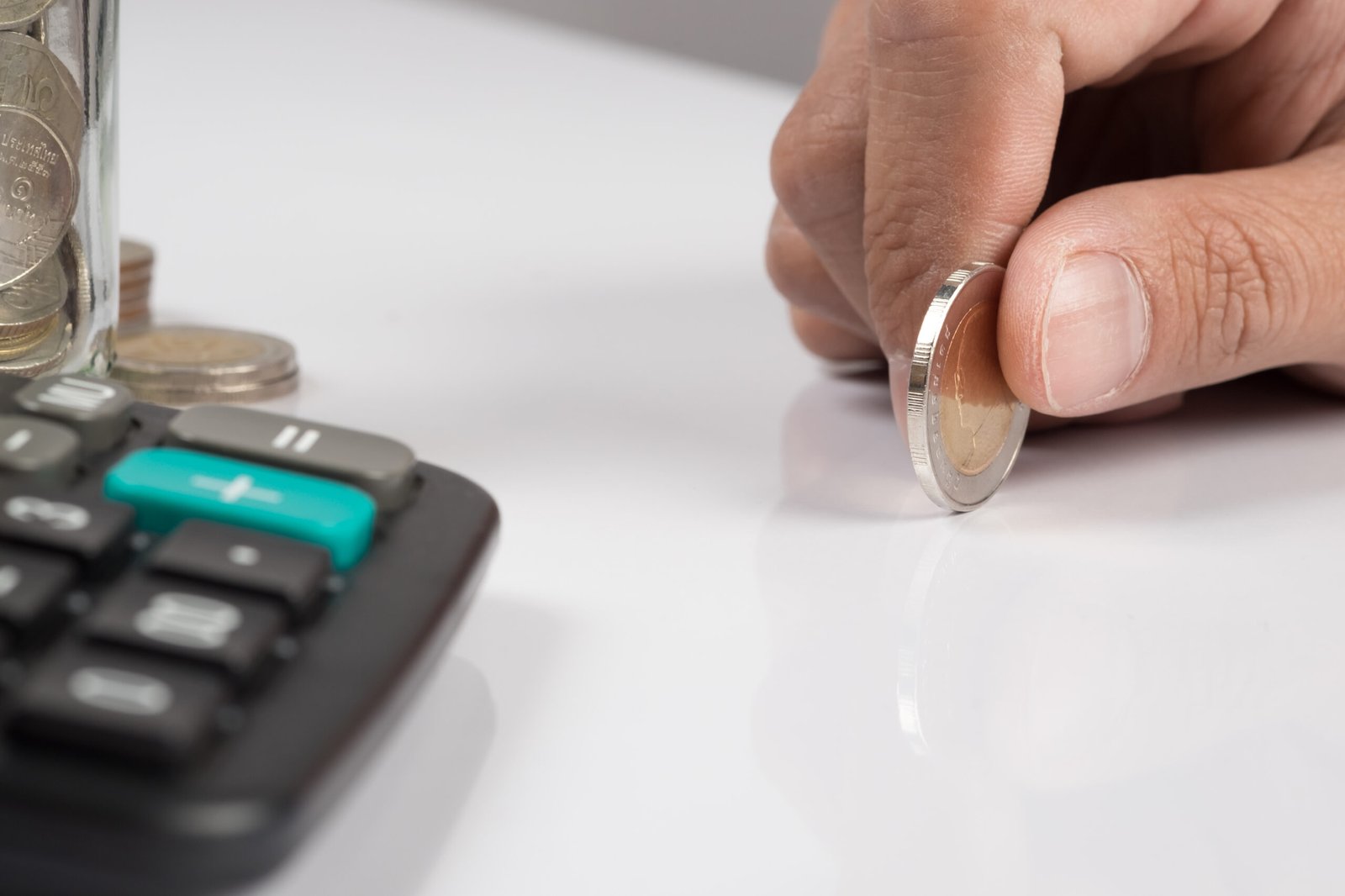 human hand holding an coin and copy space, Business investment plan concept.